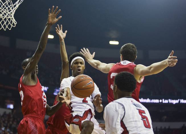 UNLV guard Patrick McCaw (2) passes the ball to teammate UNLV forward Christian Wood (5) under the basket past the Southern Utah defense during their game at the Thomas & Mack Center on Saturday, December 27, 2014.