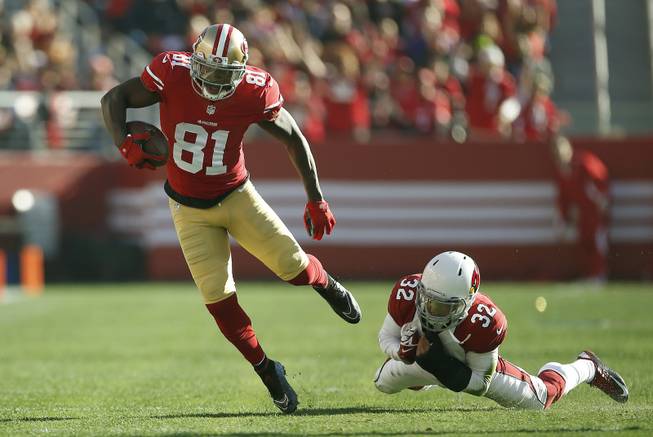San Francisco 49ers wide receiver Anquan Boldin, left, runs against Arizona Cardinals free safety Tyrann Mathieu during the first half of an NFL football game in Santa Clara, Calif., on Sunday, Dec. 28, 2014.