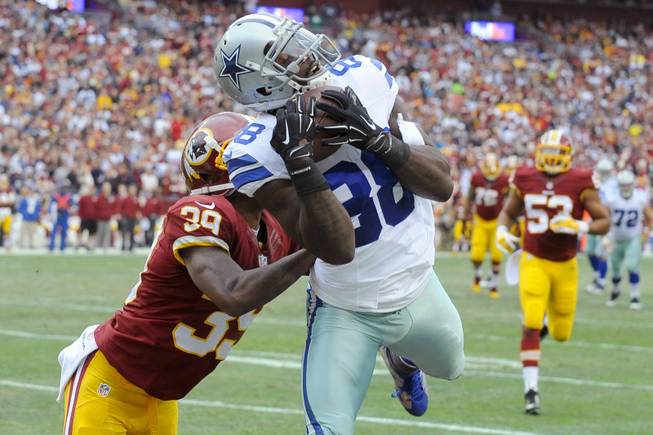 Dallas Cowboys wide receiver Dez Bryant, right, pulls in a touchdown pass under pressure from Washington Redskins cornerback David Amerson during the first half of an NFL football game in Landover, Md., on Sunday, Dec. 28, 2014.