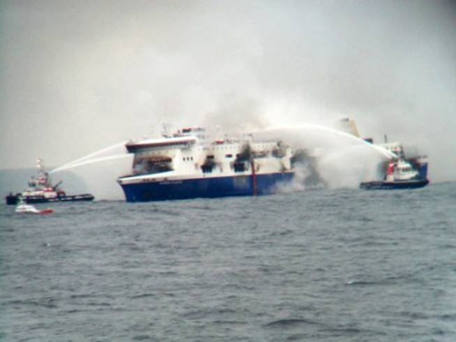 In this photo taken from a nearby ship, vessels try to extinguish the fire at the Italian-flagged Norman Atlantic after it caught fire in the Adriatic Sea on Sunday, Dec. 28, 2014. At least one person died and two were injured. The Italian Defense Ministry said 165 of the 478 people on the ferry had been evacuated by Sunday evening, more than 14 hours after the fire erupted. 