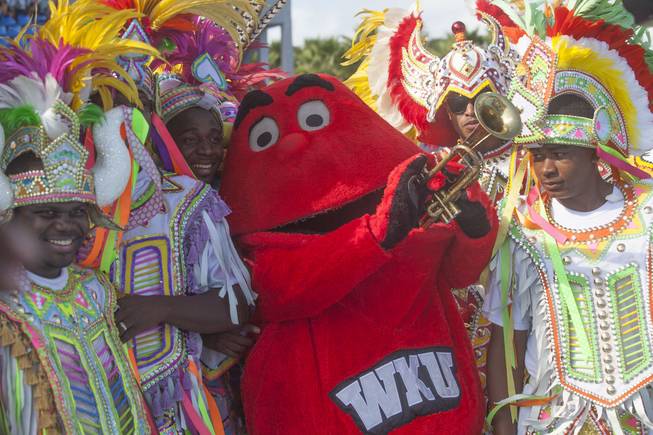 Western Kentucky mascot Big Red, center, stands with halftime act The Valley Boys during the Bahamas Bowl NCAA college football game against Central Michigan, Wednesday, Dec. 24, 2014, in Nassau, Bahamas.