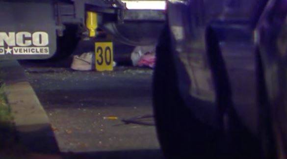 In this Dec. 30, 2014, photo taken from a video provided by WTXF Television, authorities investigate the scene after a man was shot and killed by police after he tried to use his car to run down officers seeking to arrest him in Upper Darby, Pa. The authorities said that the man had posted an online video threatening to kill police and FBI agents. 