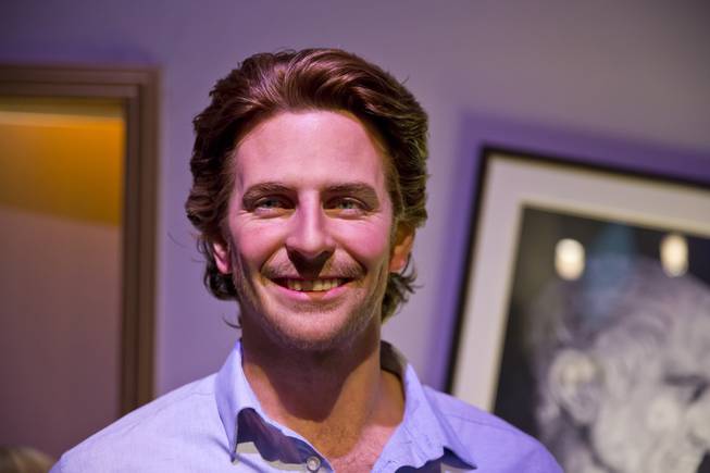A wax figure of Phil, played by Bradley Cooper stands in a re-creation of the Caesars Palace suite at Madame Tussauds' Hangover Experience, Thursday Jan 1, 2015. Las Vegas wax museum unveiled their newest wax figure Alan, played by Zach Galifianakis.