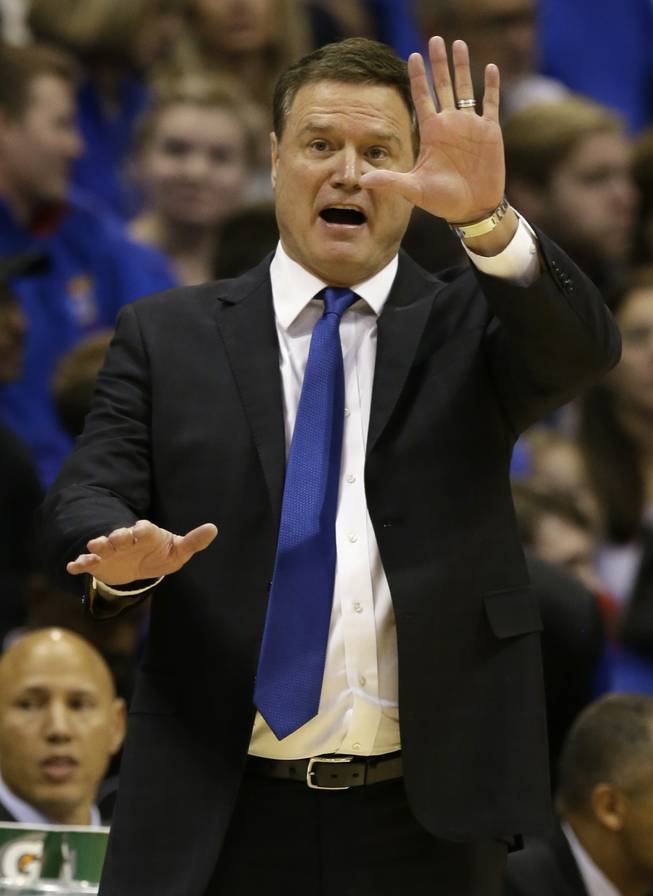 Kansas head coach Bill Self signals a play during the second half of an NCAA college basketball game against UNLV in Lawrence, Kan., on Sunday, Jan. 4, 2015.  Kansas defeated UNLV 76-61.