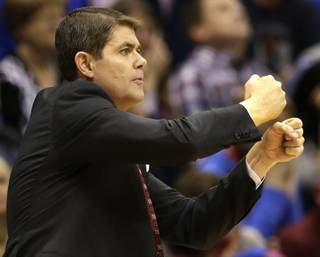 UNLV head coach Dave Rice directs his team during the first half of an NCAA college basketball game against Kansas in Lawrence, Kan., on Sunday, Jan. 4, 2015.