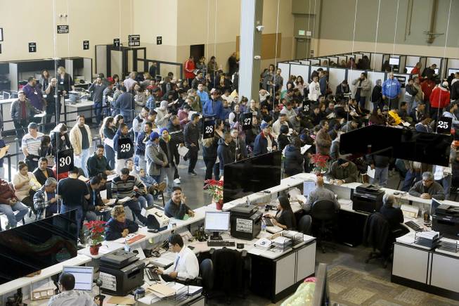 Immigrants line up at a California Department of Motor Vehicles office to register for drivers licenses in Stanton, Calif., Friday, Jan. 2, 2015. Hundreds of people packed into state offices and waited on hours-long lines Friday as California began issuing driver’s licenses to the nation’s largest population of immigrants in the country illegally. 
