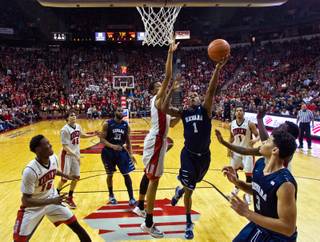 UNR guard Marqueze Coleman (1) gets off a shot just inside of UNLV forward Christian Wood (5) and others during their game at the Thomas & Mack Center on Wednesday, January 7, 2015. 