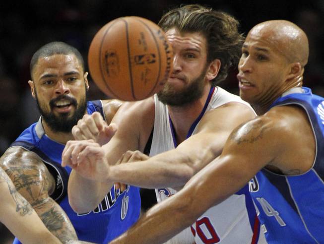 Los Angeles Clippers forward Spencer Hawes, center, battles Dallas Mavericks center Tyson Chandler and forward Richard Jefferson for a loose ball during the first half Saturday, Jan. 10, 2015, in Los Angeles.