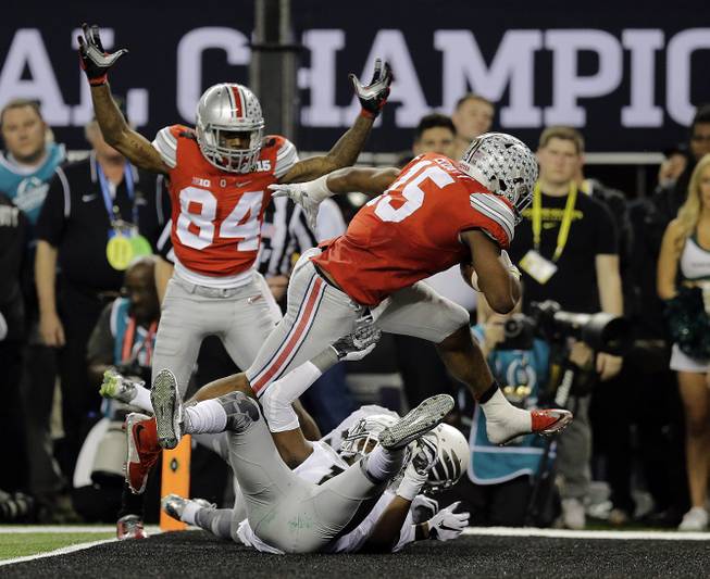 Ohio State's Ezekiel Elliott (15) runs for a nine-yard touchdown during the second half of the NCAA college football playoff championship game against Oregon Monday, Jan. 12, 2015, in Arlington, Texas. 

