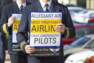 Allegiant Air pilots hold signs as they picket in front of the Allegiant Air headquarters in Summerlin Tuesday, Jan. 13, 2015. Pilots, represented by the International Brotherhood of Teamsters union, have been in contract negations with the company for two years, a union representative said.