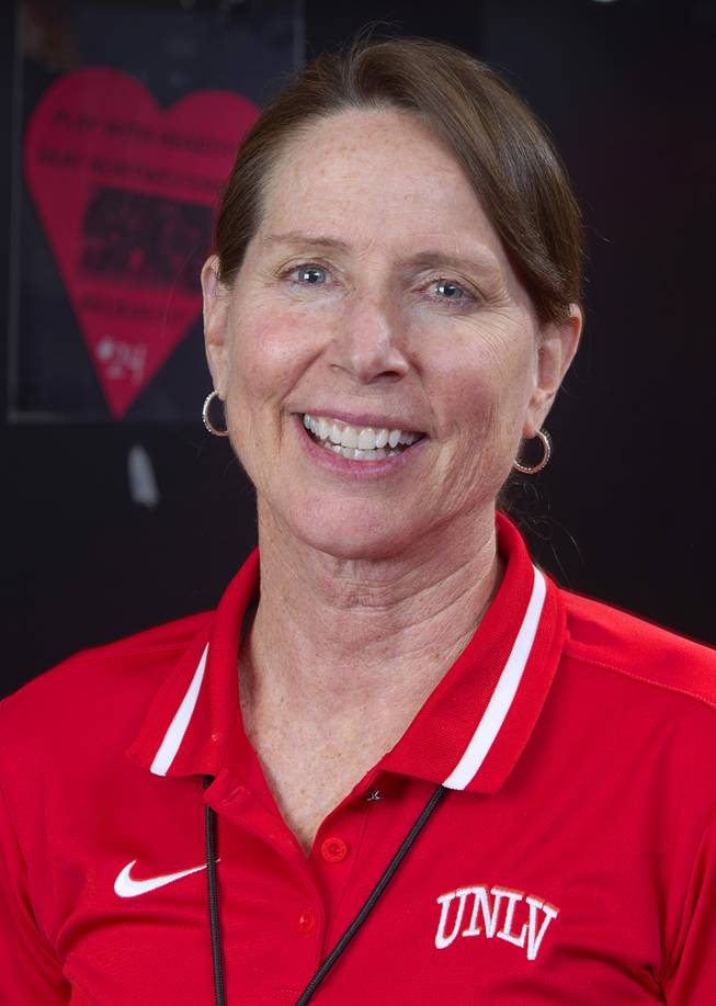 Head coach Kathy Olivier poses in the Lady Rebels locker room at UNLV Thursday, Jan. 15, 2015. Each players' locker is sponsored by a donor for $2,000  one of the many ways the program is being creative to stay afloat.