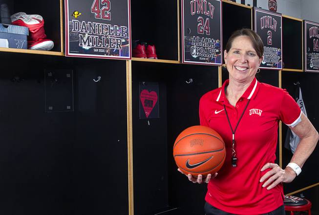 Head coach Kathy Olivier poses in the Lady Rebels locker room at UNLV Thursday, Jan. 15, 2015. Each players' locker is sponsored by a donor for $2,000  one of the many ways the program is being creative to stay afloat.