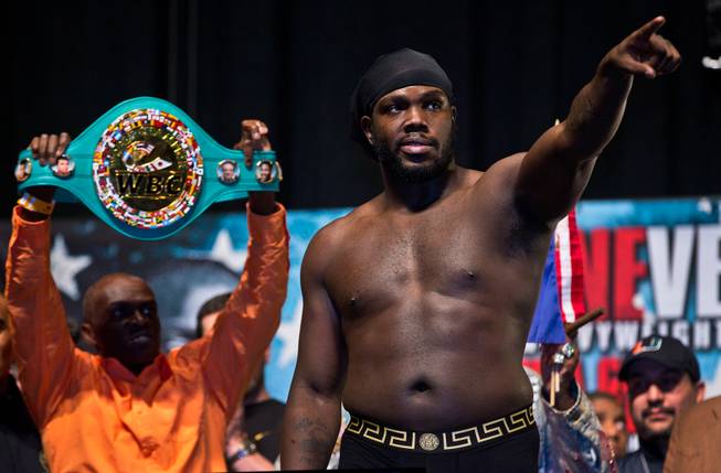 Heavyweight fighter Bermane Stiverne flexes for the fans on stage during fighter weigh ins within the MGM Grand Arena on Thursday, January 15, 2015.