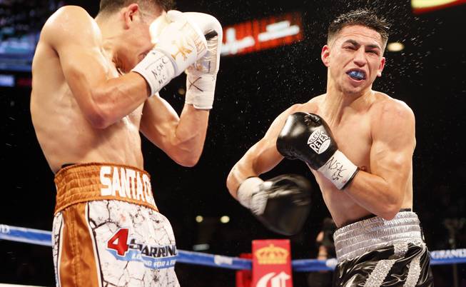 Leo Santa Cruz, left, and Jesus Ruiz, right, exchange punches in their WBC super bantamweight title fight. Santa Cruz retained his title via eighth-round TKO on the undercard of Bermane Stiverne vs. Deontay Wilder on Saturday January 17, at the MGM Grand Garden Arena.
