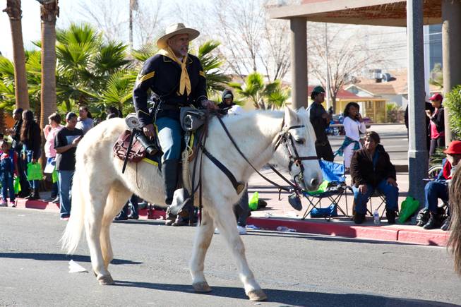 A Buffalo Soldier, Las Vegas chapter, rides horseback down Fourth Street during the 33rd Annual Dr. Martin Luther King Jr. Parade in downtown Las Vegas, Monday Jan. 19, 2015.