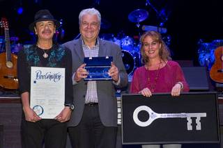 Carlos Santana, Clark County Commissioner Steve Sisolak and Roxana Drexel, director of the Hermes Music Foundation, during a ceremony at House of Blues on Wednesday, Jan. 21, 2015, in Mandalay Bay. Santana and Hermes Music U.S. were honored for their donation of 80 guitars to Monaco Middle School's music programs.
