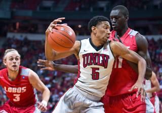 UNLV forward Christian Wood (5) drives on New Mexico center Obij Aget (11) to the basket during their game at the Thomas & Mack Center on Wednesday, January 21, 2015.
