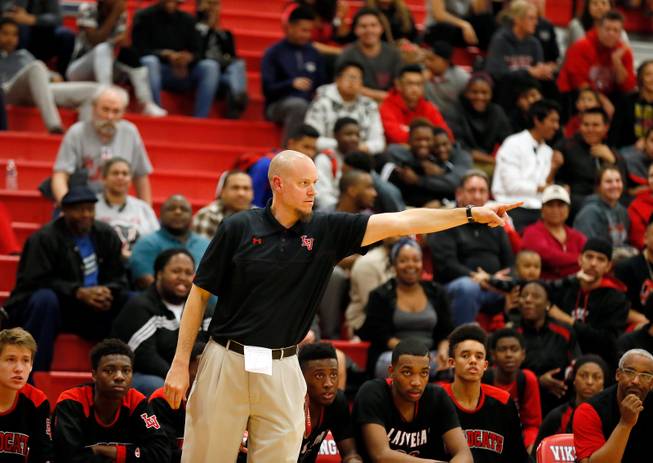 Las Vegas High head coach Jason Wilson directs his players on the court during their rivals basketball game on Tuesday, January 20, 2015.