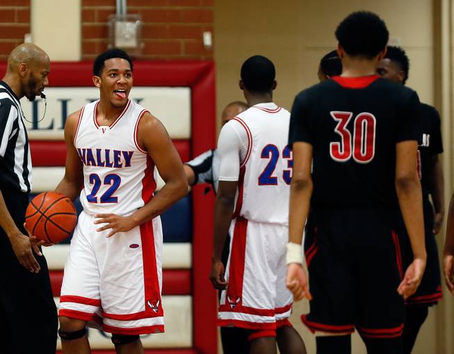 Valley High player Shea Garland (22) sticks his tongue out at Las Vegas High player Tyler Bey (30) during their rivals basketball game on Tuesday, January 20, 2015.