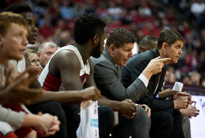 UNLV coaches and players stay active on the bench during their game at the Thomas & Mack Center on Wednesday, January 21, 2015.
