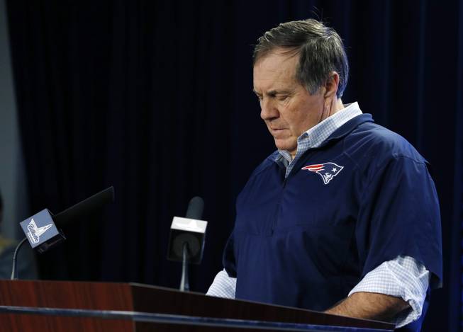 New England Patriots head coach Bill Belichick reads from notes as he speaks during a news conference prior to a team practice in Foxborough, Mass., Thursday, Jan. 22, 2015. Belichick addressed the issue of the NFL investigation of deflated footballs.