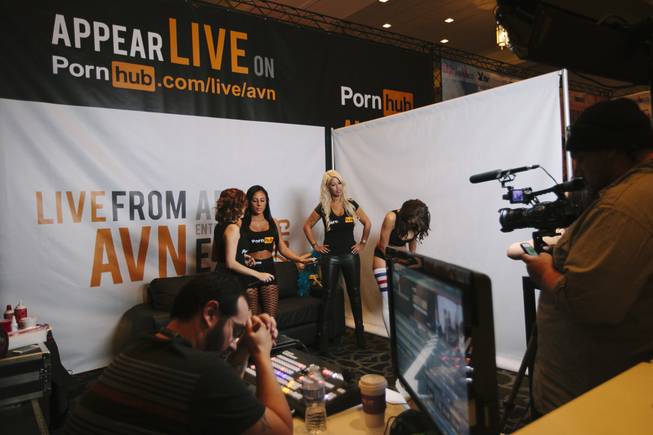 Attendees wait to take photos with models at the Pornhub booth at the 2015 AVN/Adult Entertainment Expo on Friday, Jan. 23, 2015, at the Hard Rock Hotel.