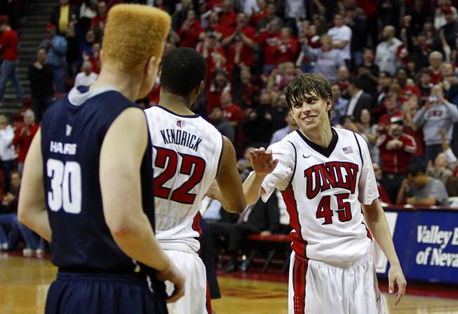 UNLV guard Cody Doolin (45) is congratulated by Jelan Kendrick after sinking his first of two free throws in overtime at the Thomas & Mack Center on Saturday, Jan. 24, 2015.