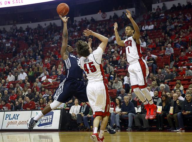 Utah State guard Darius Perkins (2) is covered by UNLV's Cody Doolin (45) and Rashad Vaughn (1) as he takes a shot during their games at the Thomas & Mack Center Saturday, Jan. 24, 2015.