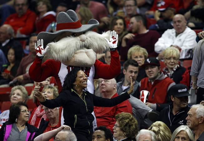 A woman dances with UNLV mascot Hey Reb as the UNLV Rebels take on Utah State at the Thomas & Mack Center Saturday, Jan. 24, 2015.
