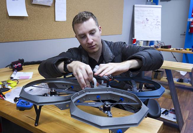 Greg Friesmuth, CEO/founder, installs a battery in the Qua.R.K. (Quad Rotor Research Kit) drone at SkyWorks, a company producing research drones, in Henderson Monday, Jan. 26, 2015.
