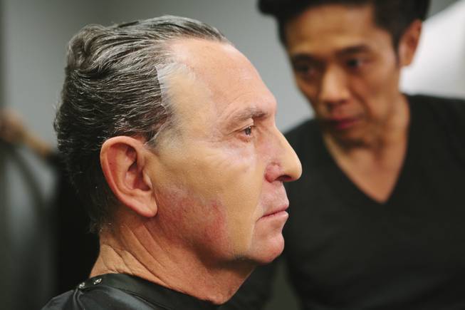Kazu Tsuji works on the makeup for Bob Anderson, who ...