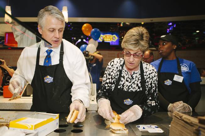 Clark County Commissioner Chris Giunchigliani, from right, prepares sliders the grand opening of White Castle on the Strip, along with company executive Dave Rife at the Best Western Plus Casino Royale on the Strip on Jan. 27, 2015.