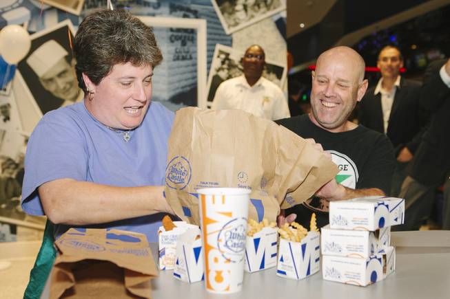Linda Kitchel, left, and Newman are the first customers served at the grand opening of White Castle at the Best Western Plus Casino Royale on the Strip on Jan. 27, 2015.