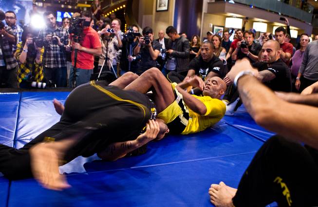 UFC 183 fighter Anderson Silva wraps up a training partner during 'workouts' open to the public at the MGM Grand Casino floor on Wednesday, January 28, 2015.