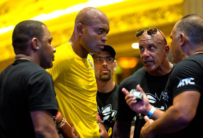 UFC 183 fighter Anderson Silva consults with his team during 'workouts' open to the public at the MGM Grand Casino floor on Wednesday, January 28, 2015.