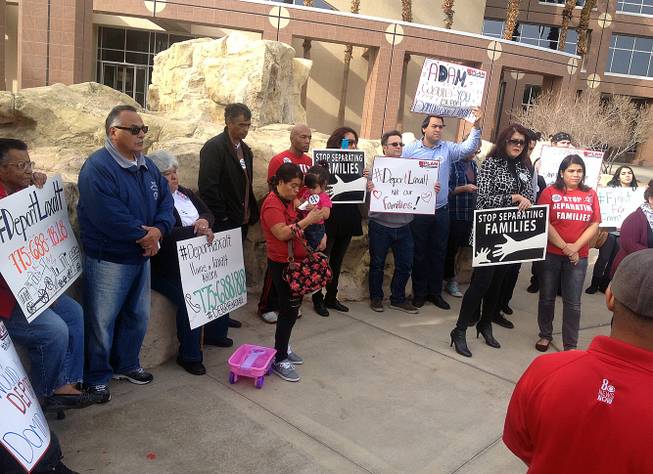 About 25 activists gathered outside Attorney General Adam Laxalt's Las Vegas office Wednesday to criticize his plan to join a lawsuit against President Barack Obama's new immigration plan.
