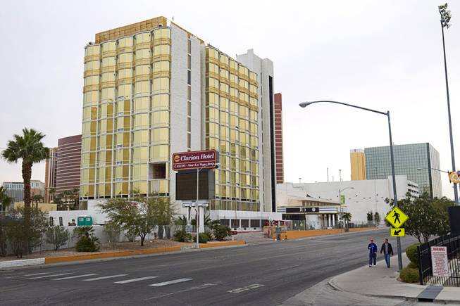 Pedestrians pass by the Clarion Hotel and Casino, 305 Convention Center Drive, Thursday, Jan. 29, 2015. The hotel, previously known as the Debbie Reynolds, Greek Isles, Paddlewheel, Royal Americana and Royal Inn, is slated for implosion on Feb. 10.