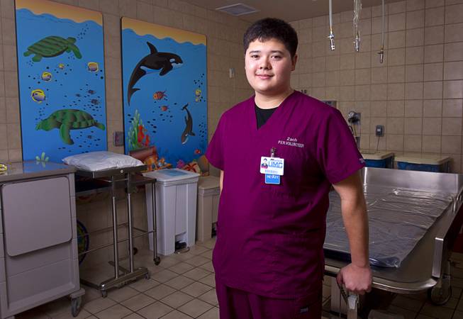 Burn unit volunteer Zachary Ching poses in a pediatric shower room at University Medical Center on Thursday, Jan. 29, 2015. Ching raised money to provide Bluetooth speakers in the unit so patients can listen to their favorite music in their rooms or while undergoing painful dressing changes. 