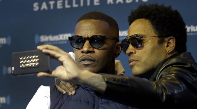 Singer Lenny Kravitz, right, takes a self portrait with Jamie Foxx after an appearance on Foxx’s SiriusXM show Friday Jan. 30, 2015, in Phoenix. Kravitz is performing alongside Katy Perry in the halftime show during Super Bowl XLIX on Sunday and said he is rooting for the Seattle Seahawks. 
