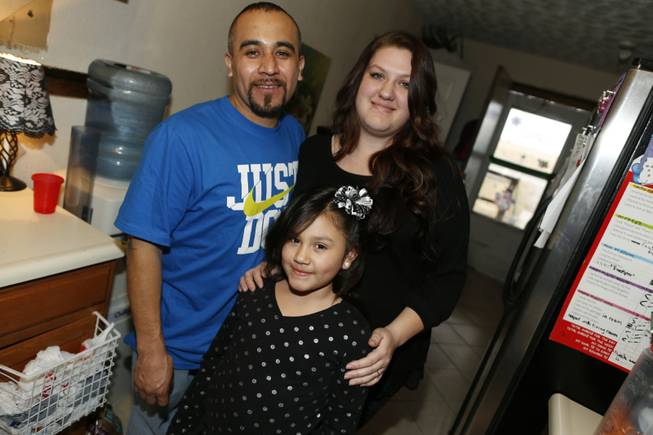Maximiano Vazquez-Guevara, left, his wife Ashley Bowen and their 6-year-old daughter, Nevaeh Vazquez, pose for a photo in their home Saturday, Jan. 31, 2015, in the northeast Denver suburb of Commerce City, Colo. The presidential executive order that fast-tracked immigration hearings for last summer's flood of Central American migrants may have had unintended consequences in canceling hearings for non-detained immigrants with longstanding cases such as Vazquez-Guevara. Vazquez-Guevarra, 34, recently won his appeal to become a legal permanent resident. But his case still needs to go in front of an immigration judge one last time, and it has been pulled from the docket. Thousands of immigrants seeking legalization through the U.S. court system have had their hearings canceled and are being told by the government that it may be 2019 or later before their futures are resolved.