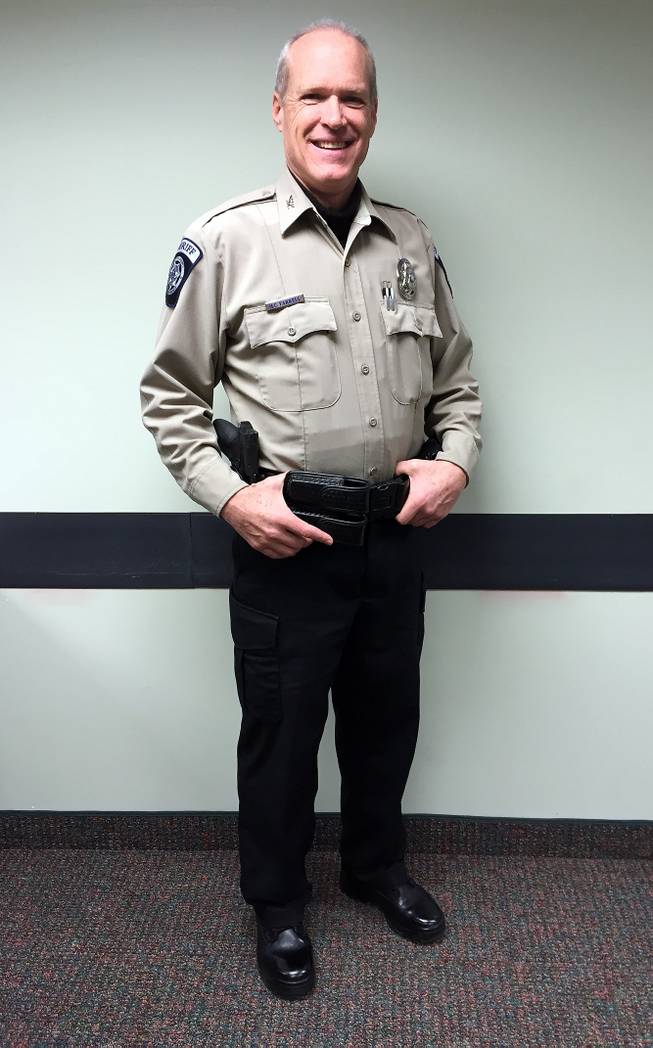 This photo shows Undersheriff Mark Farrell wearing a new uniform at the Sheriff’s Office on Monday, Feb. 2, 2015, in Pinedale, Wyo. The new sheriff of a Wyoming county has banned his deputies from wearing cowboy hats and cowboy boots.