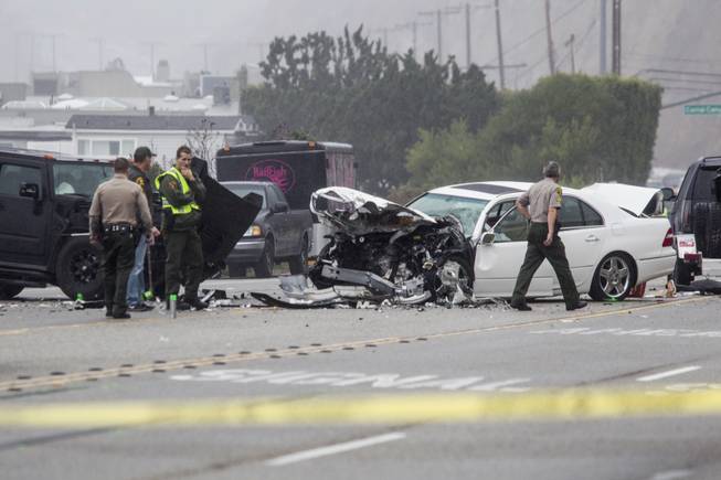 Los Angeles County Sheriff's deputies investigate the scene of a collision involving three vehicles in Malibu, Calif., on Saturday, Feb. 7, 2015. Former Olympian Bruce Jenner was in one of the cars involved in the Pacific Coast Highway crash. 