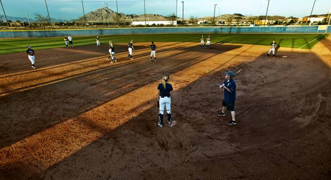 CSN softball team head coach Callen Perreira hits to infielders during practice at the Russell Road Sports Complex on Wednesday, February 4, 2015.