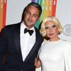 In this Dec. 7, 2014, photo, Taylor Kinney and Lady Gaga attend the 37th Annual Kennedy Center Honors in Washington, D.C. Gaga announced on her Instagram account Monday, Feb. 16, 2015, that Kinney and she are engaged, and her representative confirmed. Kinney stars on NBC’s “Chicago Fire.” Gaga won her sixth Grammy Award this month for her album with Tony Bennett, “Cheek to Cheek.”