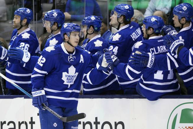 Toronto Maple Leafs forward Tyler Bozak (42) is congratulated by teammates after scoring against the Florida Panthers during the first period of an NHL hockey game at the Air Canada Centre in Toronto on Tuesday, Feb. 17, 2015.