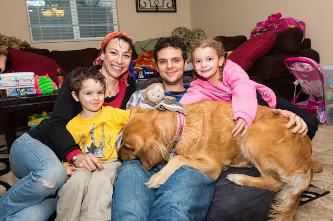 Three-year-old Elann Saula poses with his family, left to right, Leslie, Sami, Kinalone and dog Gadji, at his home in Las Vegas.