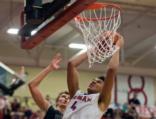 Bishop Gorman player Chase Jeter (4) gets to the hoop before Palo Verde player Grant Dressler during the Sunset Regional championship high school basketball game on Friday, February, 20, 2015.
