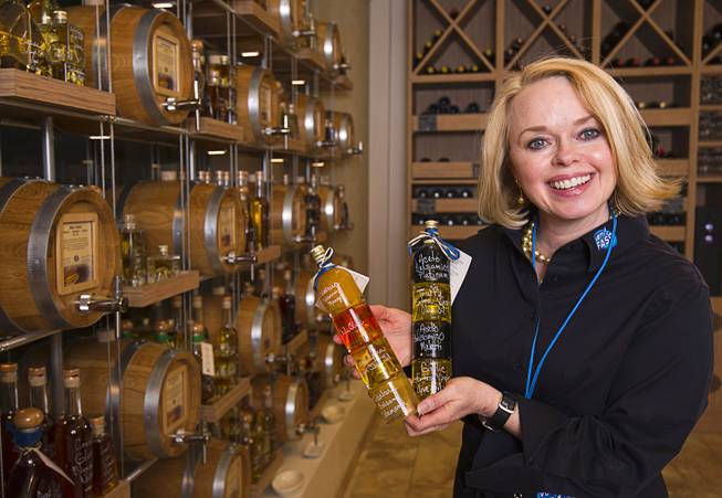 Owner Kim Weiss poses with bottles of specialty oils and vinegar in VOM FASS at the Grand Canal Shoppes in the Venetian Tuesday, Feb. 24, 2015. The store sells whiskeys and liqueurs on tap and lets shoppers sample them before purchasing. The company also sells wine, specialty oils and vinegars.