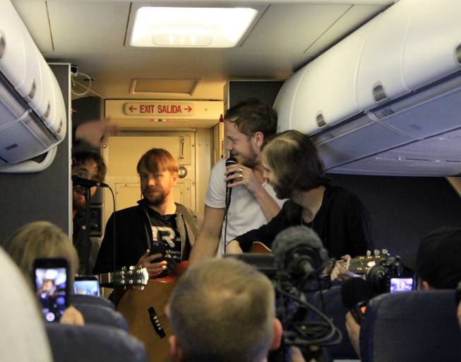 Members of Imagine Dragons, from left, a nearly hidden Daniel Platzman, Ben McKee, Dan Reynolds and Wayne Sermon are shown during a "Destination Dragons" in-flight performance on Tuesday, Feb. 24, 2015.