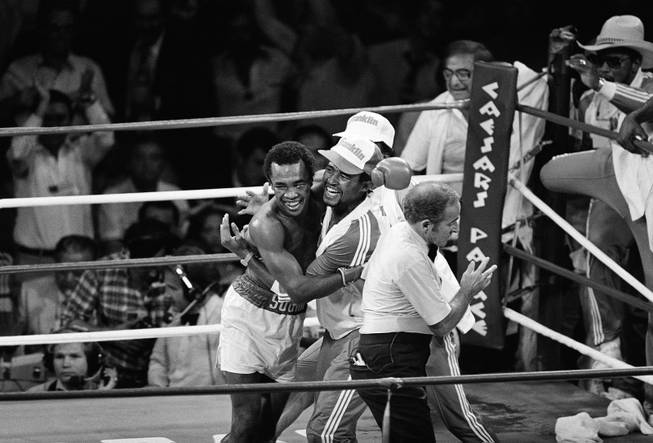 Boxing Welterweight Champion Sugar Ray Leonard hugs his handler after winning the title in a fight against Thomas Hearns in Las Vegas September 16, 1981.  (AP Photo)